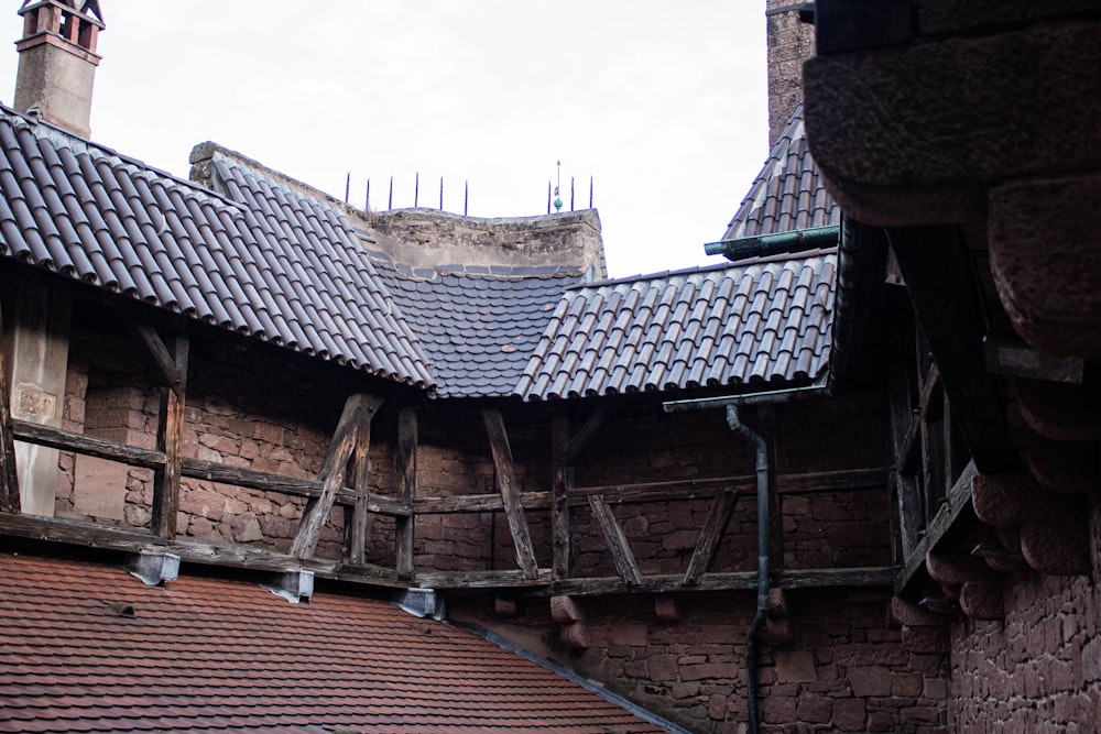 the roof of a building with a clock tower in the background