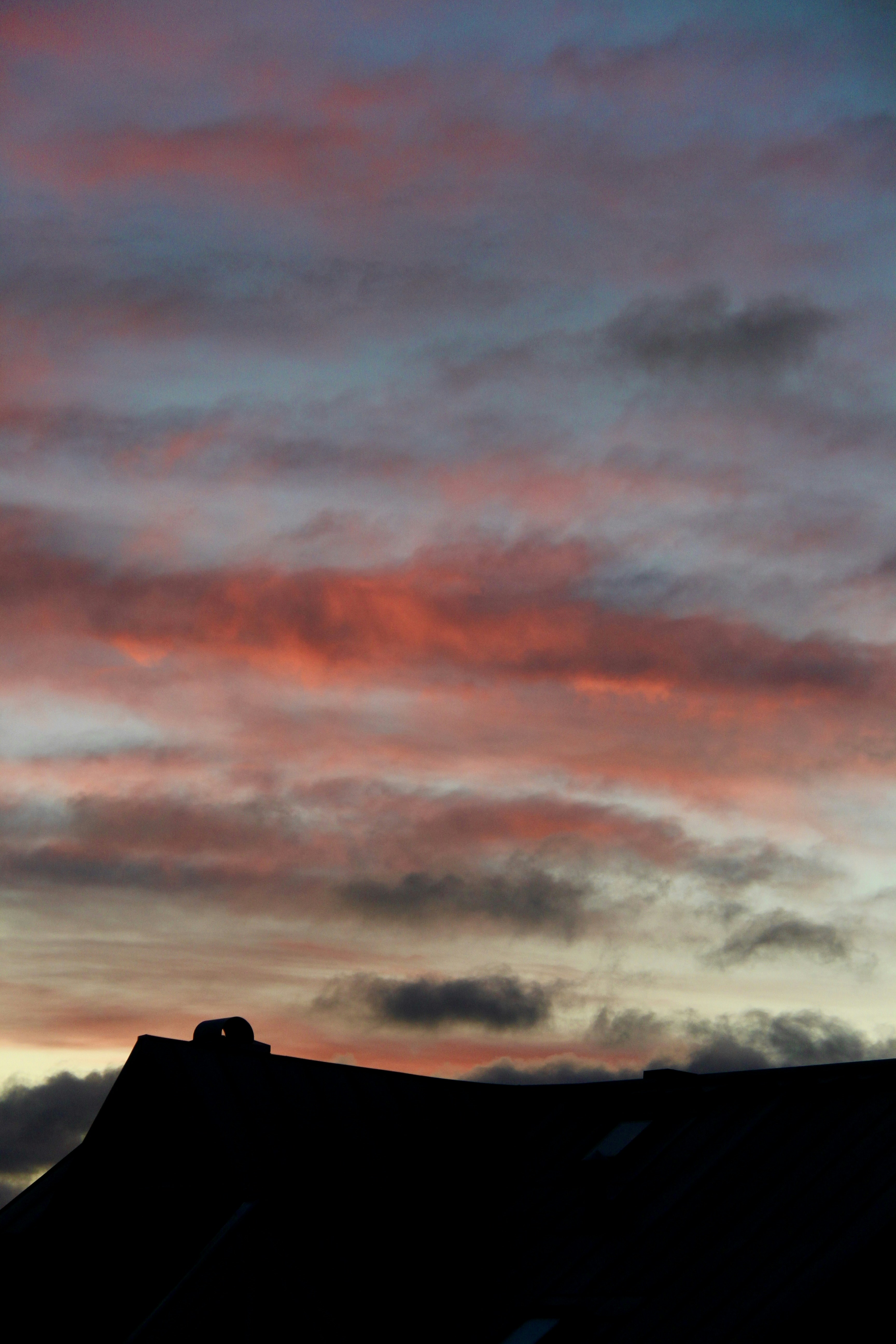 a red and blue sky with some clouds