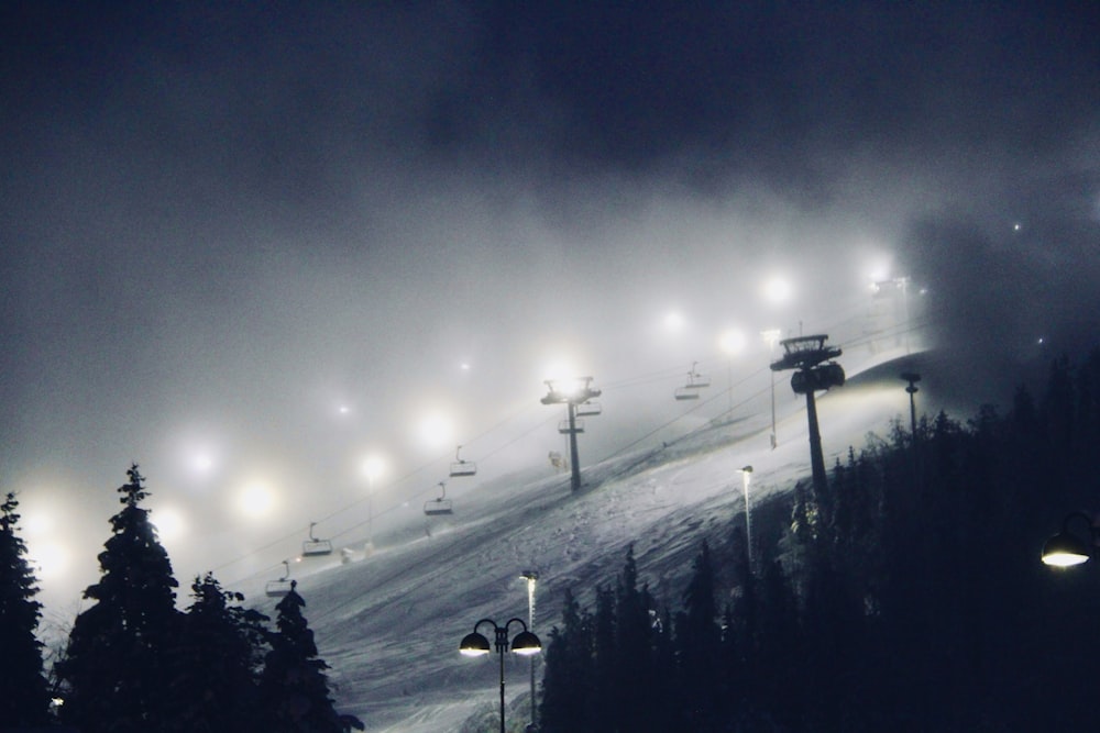 a ski slope covered in lots of snow at night