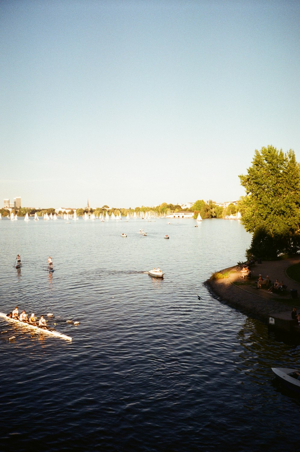 a group of people rowing a boat on a lake