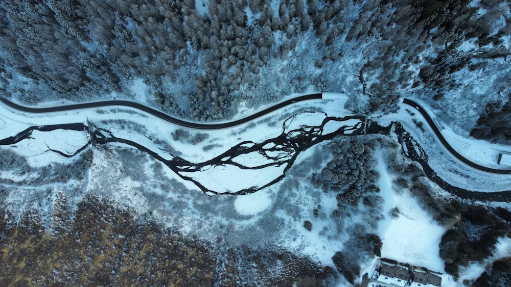 an aerial view of a winding road in the snow