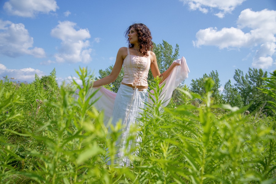 a woman standing in a field of tall grass