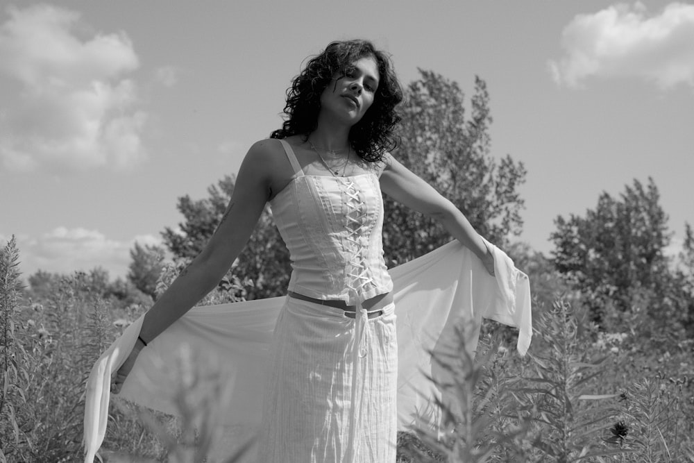 a woman in a dress standing in a field