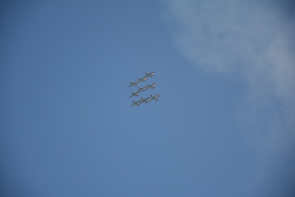 푸른 하늘에 대형을 이루어 비행하는 비행기 4대