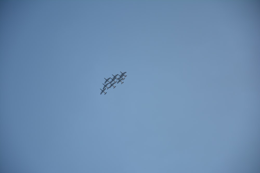 a group of airplanes flying through a blue sky