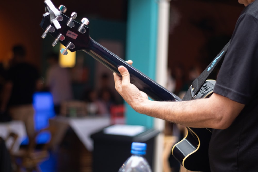 a man holding a guitar in his hands