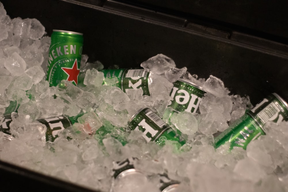 a can of heineken beer sitting in a pile of ice