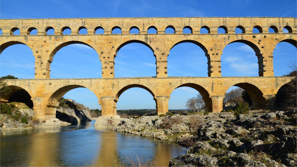 a large stone bridge spanning over a river