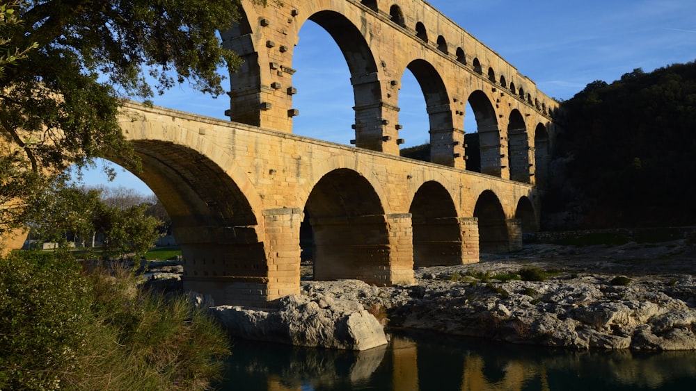 an old stone bridge over a body of water