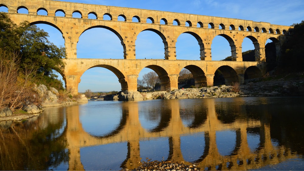 a large stone bridge spanning over a river