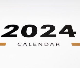 a white wall with a black and orange calendar on it