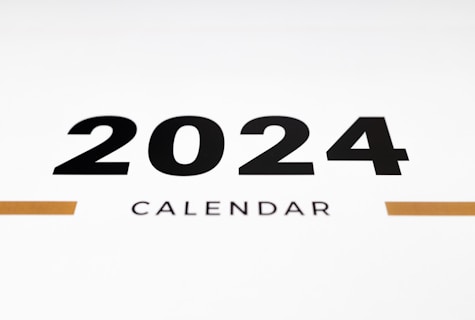 a white wall with a black and orange calendar on it