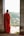 a person in a red robe looking out of a doorway