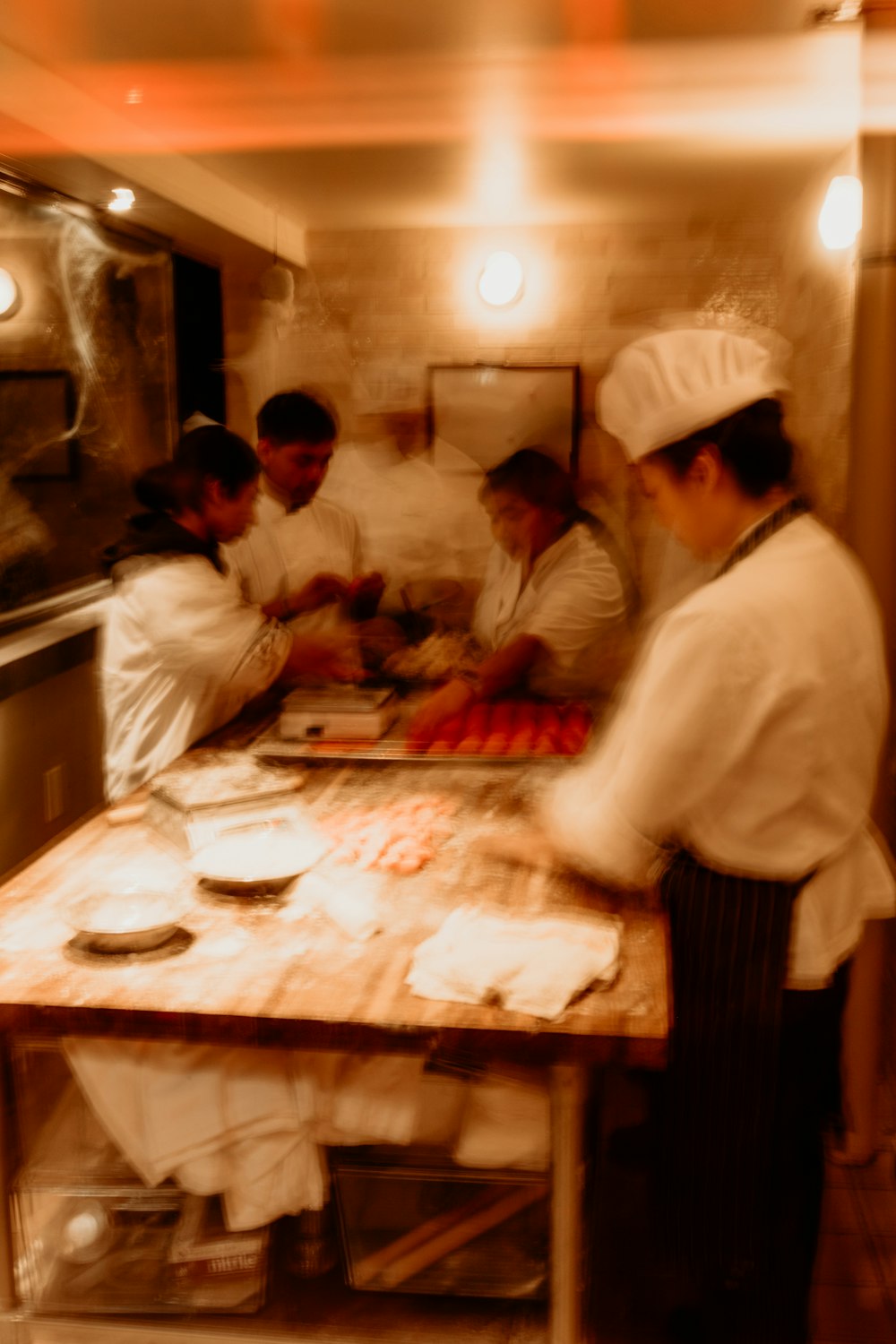 a group of chefs preparing food in a kitchen