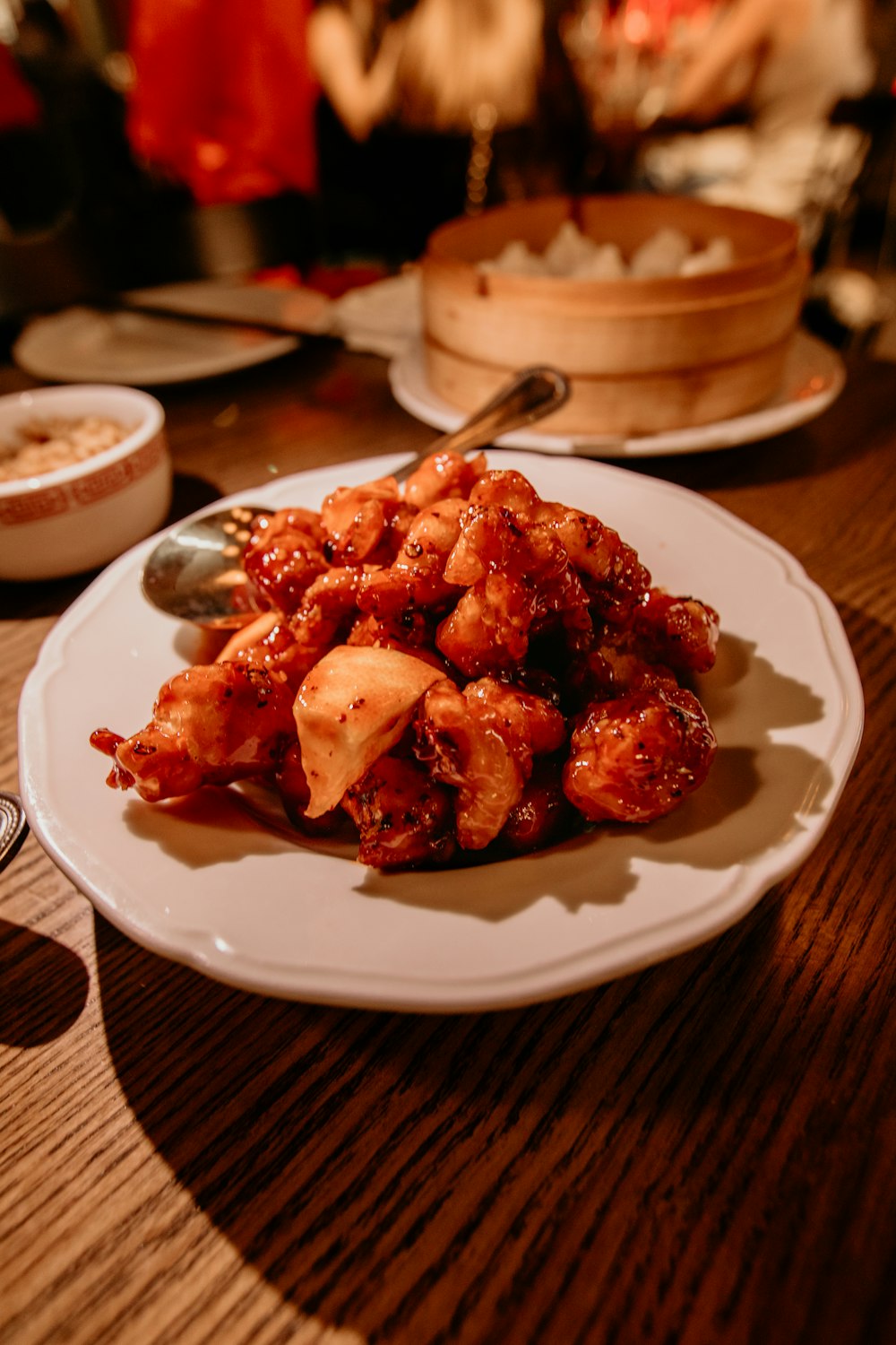 a white plate topped with fried food on top of a wooden table