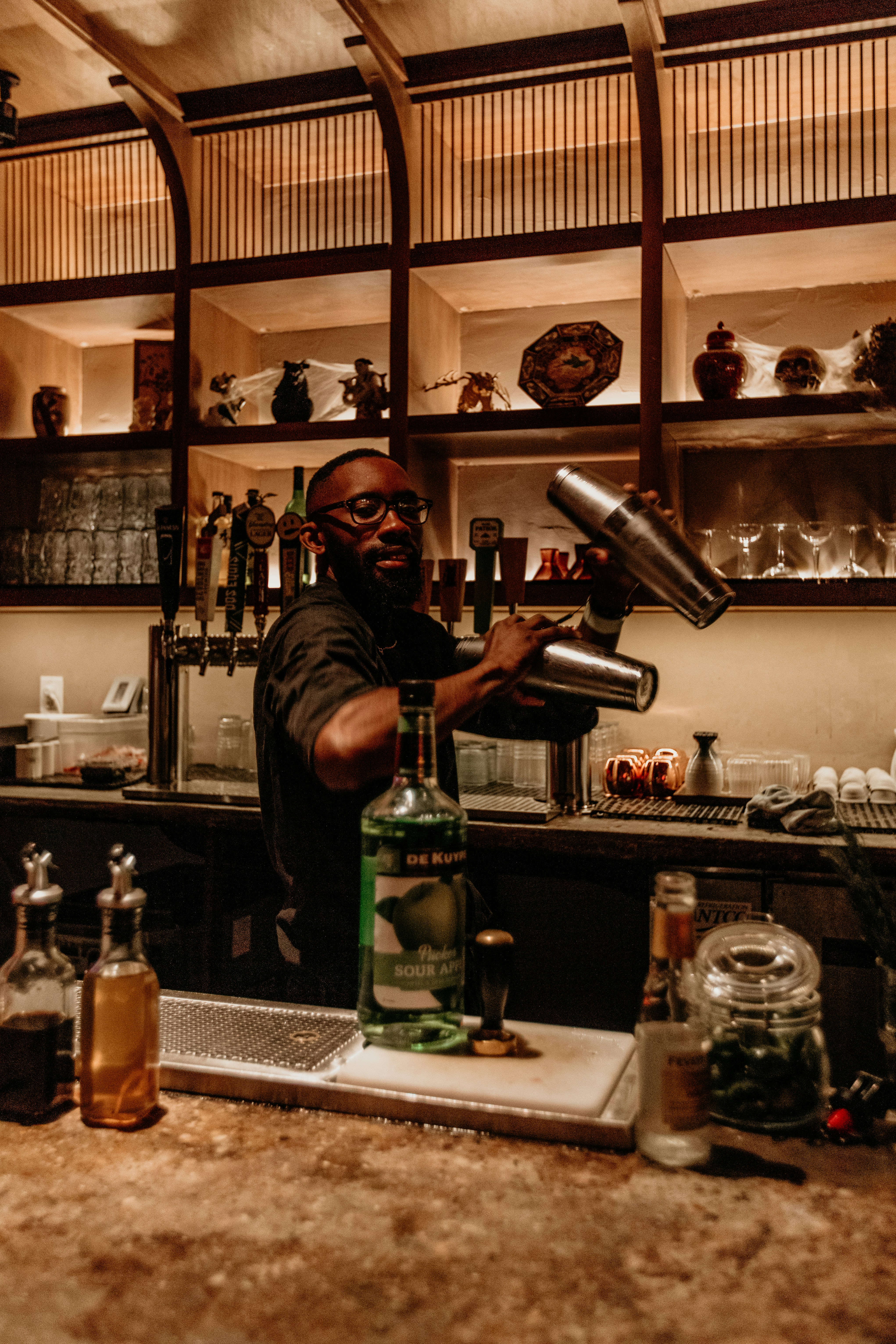 a man pouring a drink into a glass