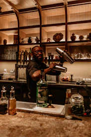 a man pouring a drink into a glass