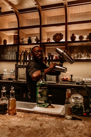 a man pouring a drink into a glass