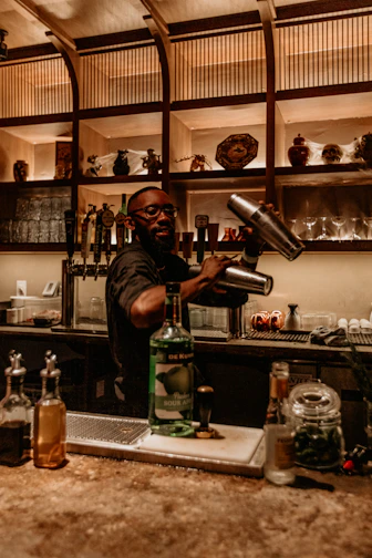 a man pouring a drink into a glass