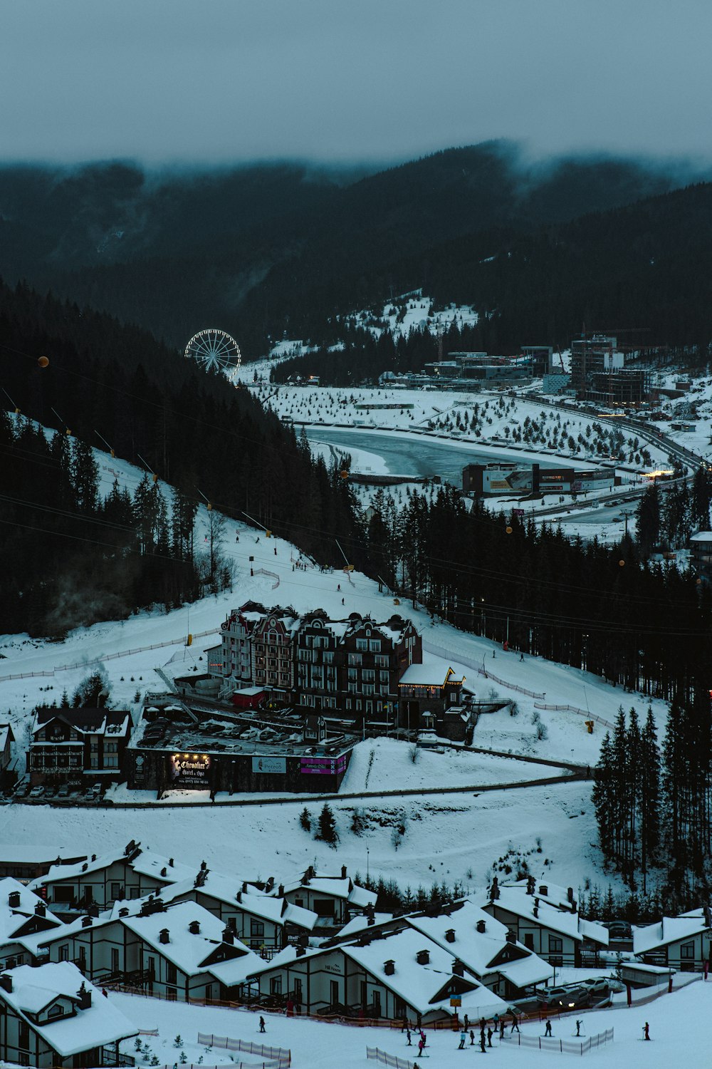 a ski resort surrounded by snow covered mountains
