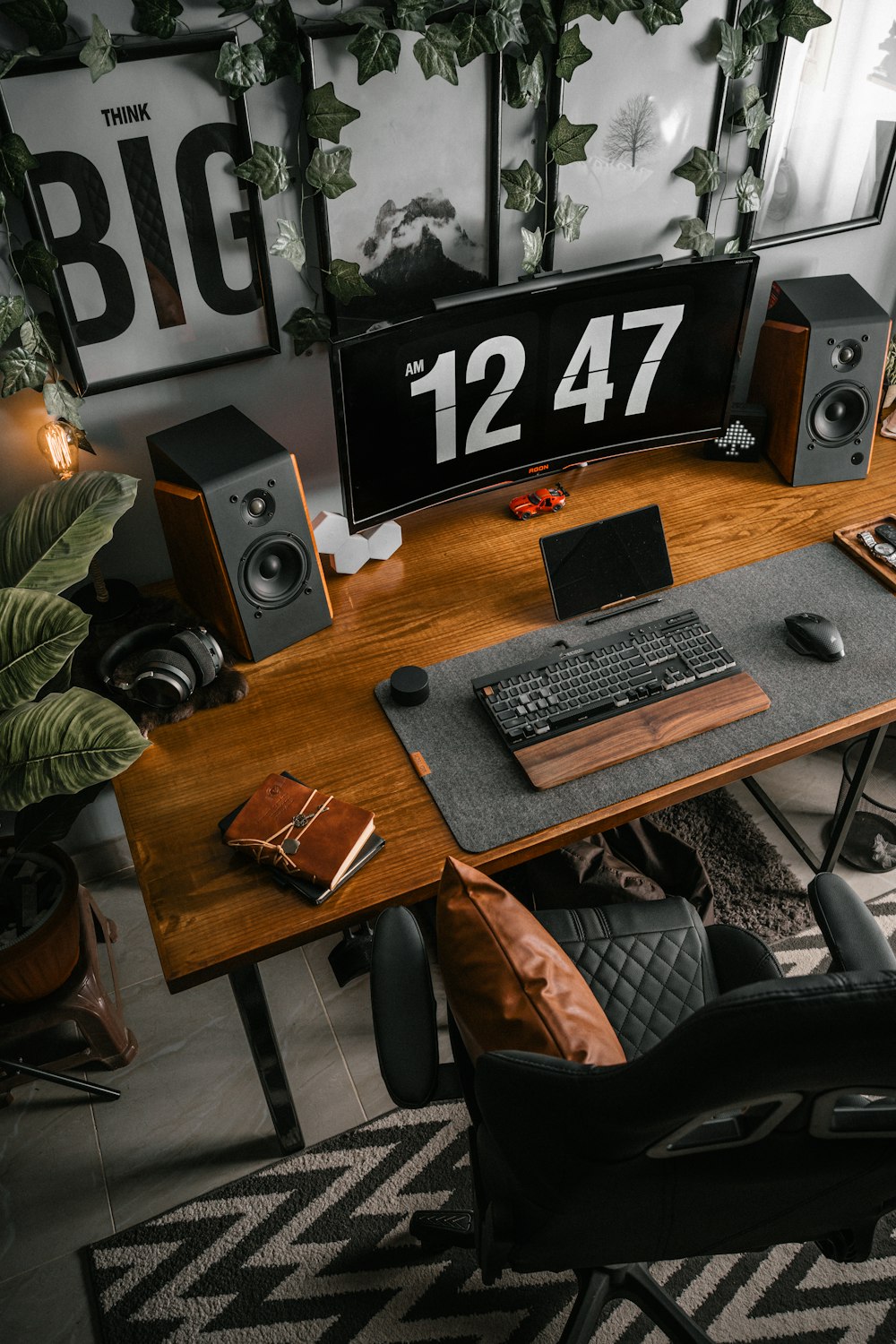 a desk with a computer and speakers on it