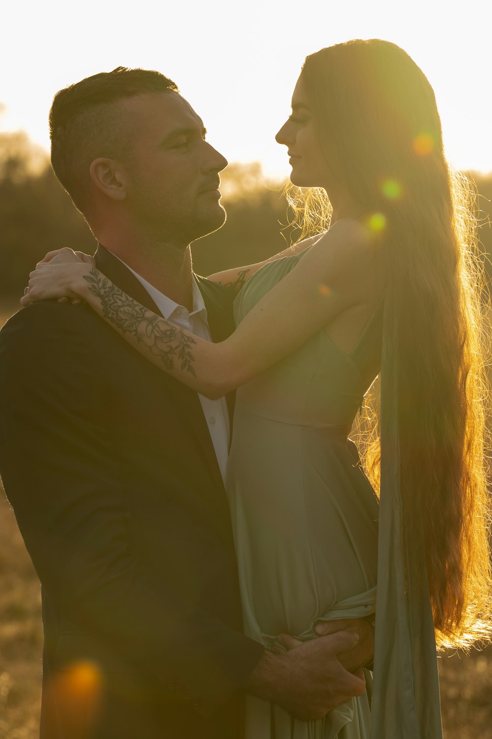 a man and a woman standing in a field