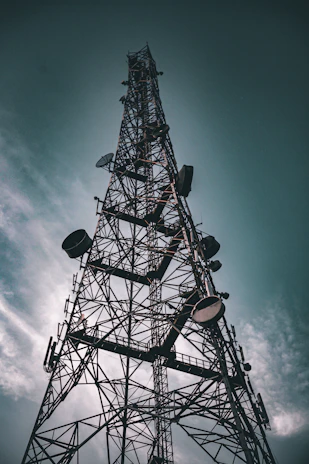 a very tall metal tower with lots of lights on it