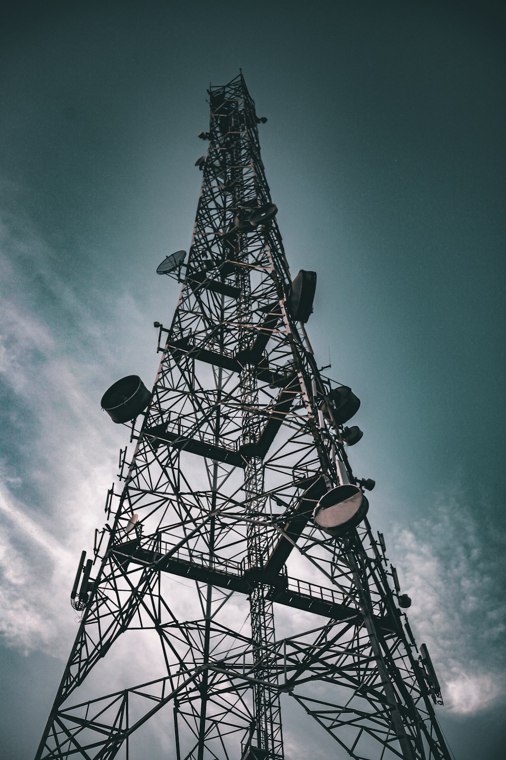 a very tall metal tower with lots of lights on it