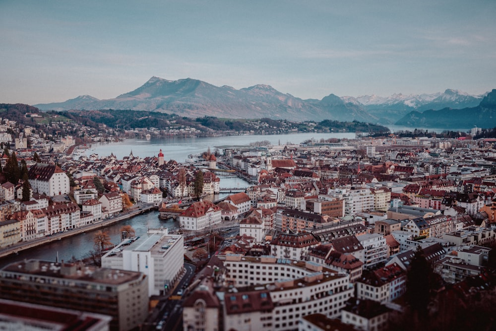 an aerial view of a city with mountains in the background