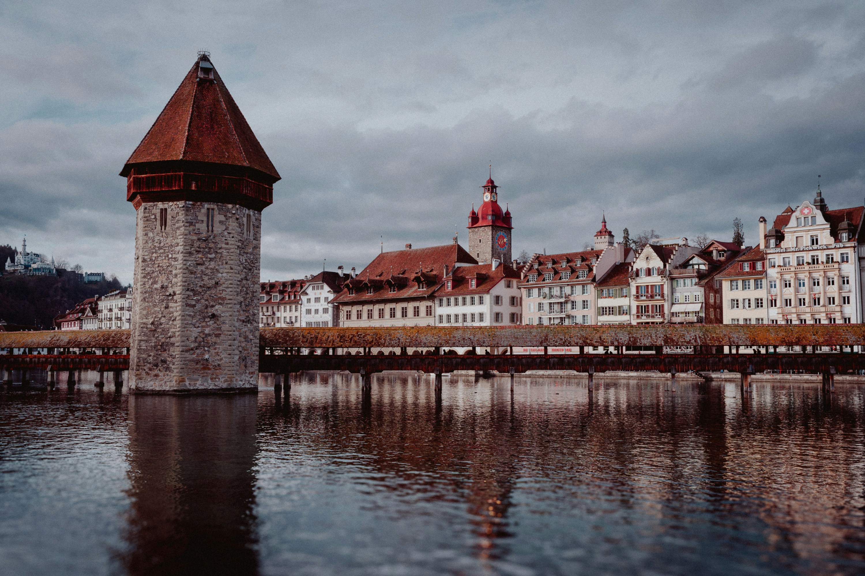 Bridge over the river in Lucerne with historic buildings nearby