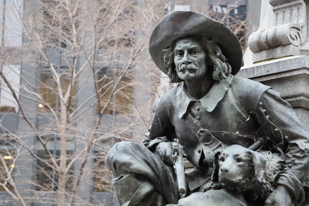 a statue of a man with a dog in his lap