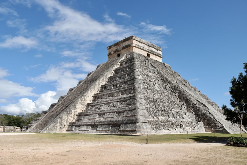 a large pyramid in the middle of a field