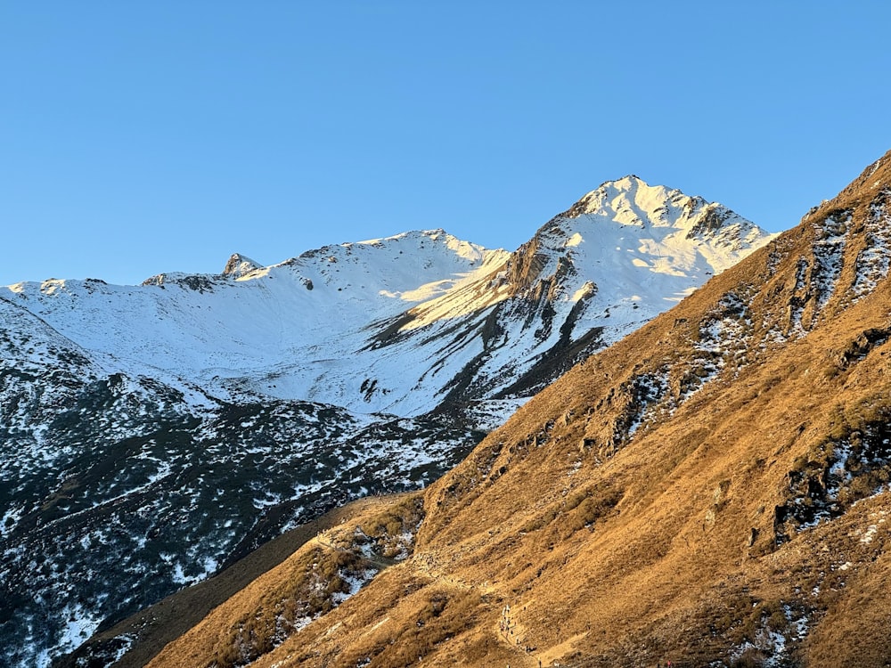 a view of a mountain range with snow on it