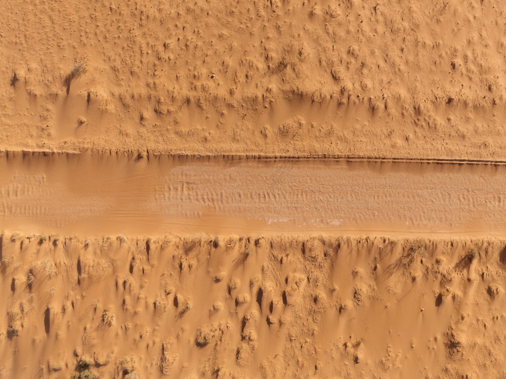an aerial view of a body of water in the desert