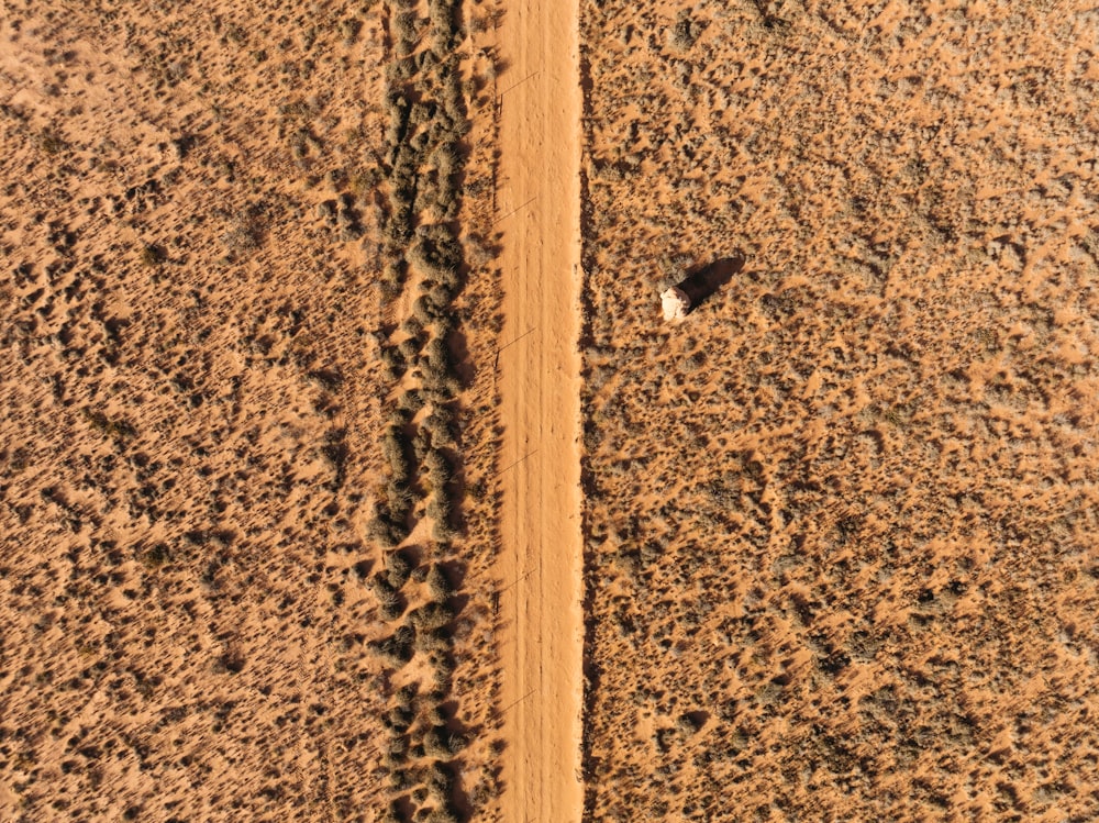 an aerial view of a dirt road in the desert