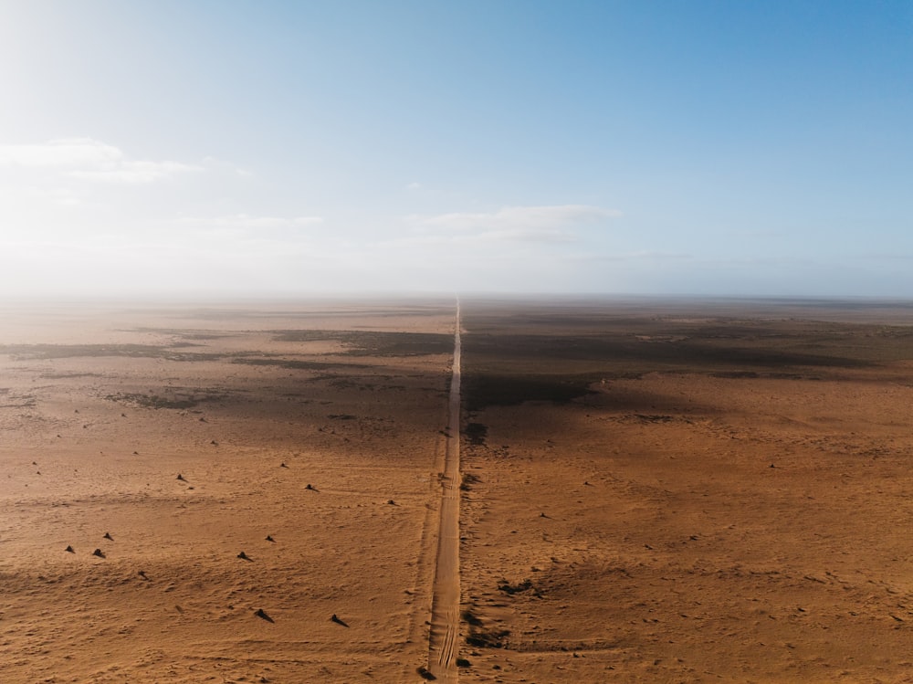 a dirt road in the middle of a desert