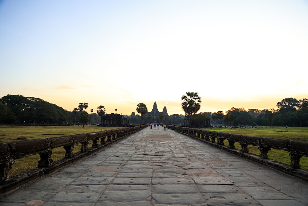 a stone walkway leading to a grassy field