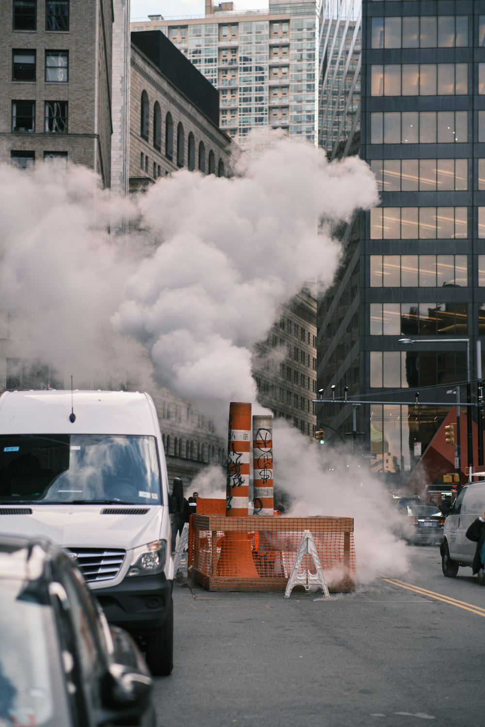 a truck driving down a street with a lot of smoke coming out of it