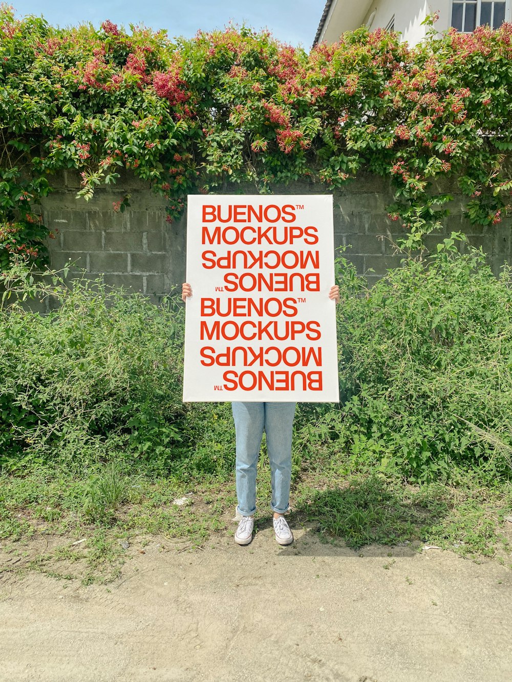 a man holding a sign in front of a building