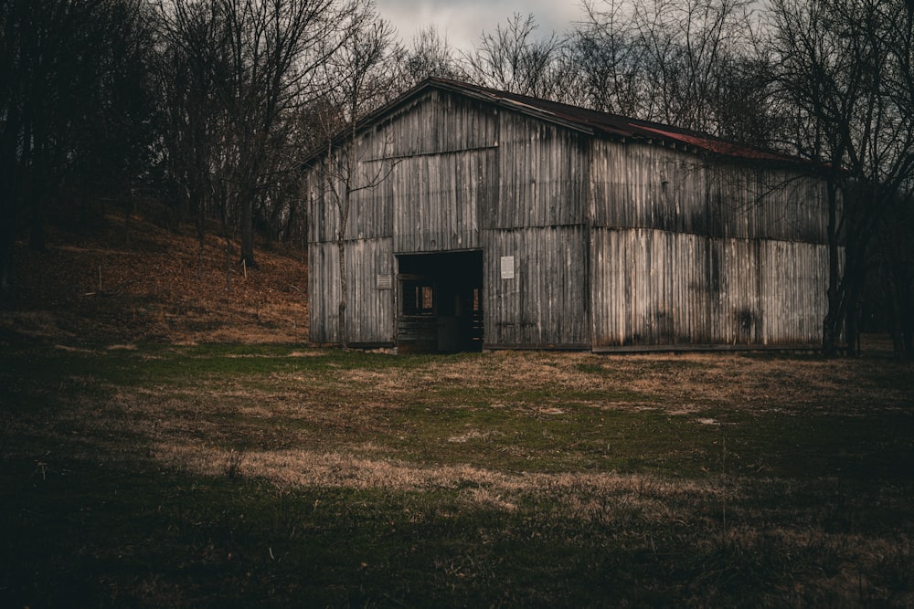 an old wooden barn with a red roof