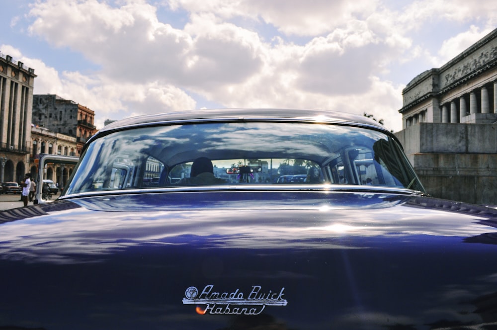 a blue car parked on the side of the road