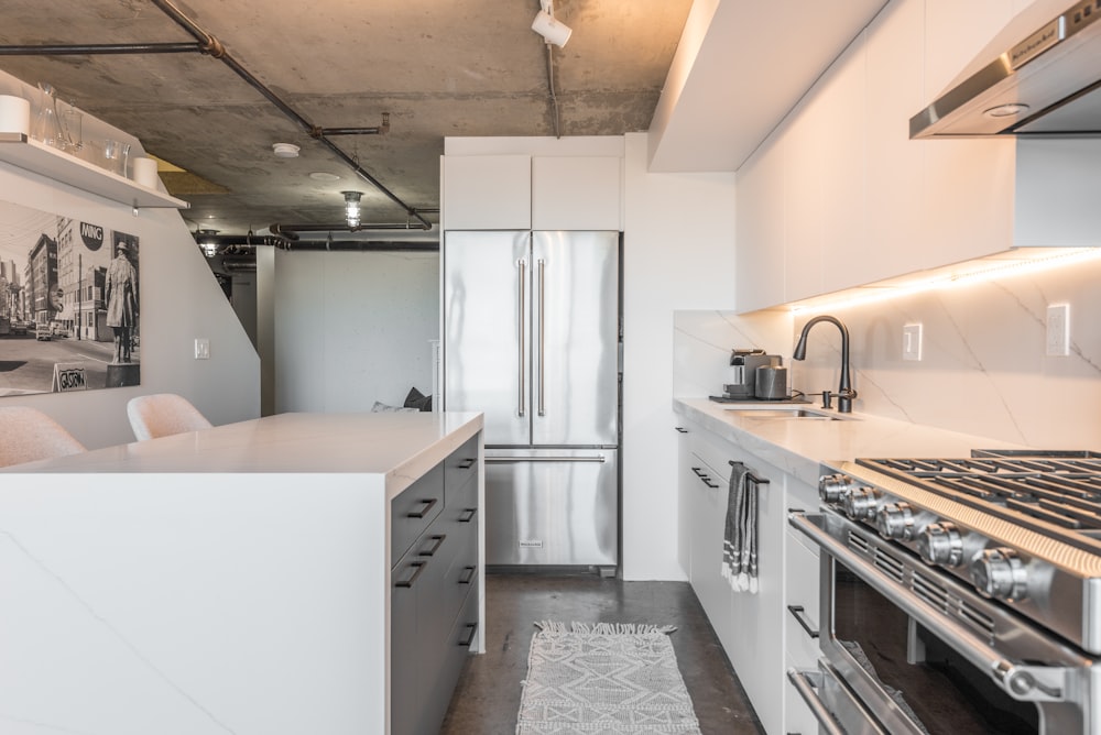 a kitchen with a refrigerator, stove, oven and microwave