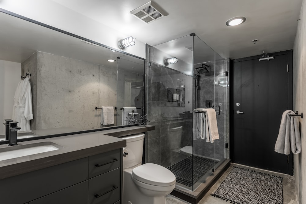 a bathroom with a shower, toilet and sink