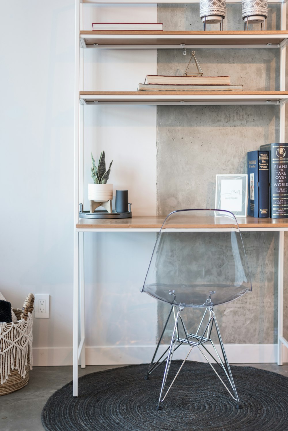 a room with a book shelf and a chair