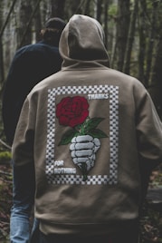 a person wearing a jacket with a rose on it
