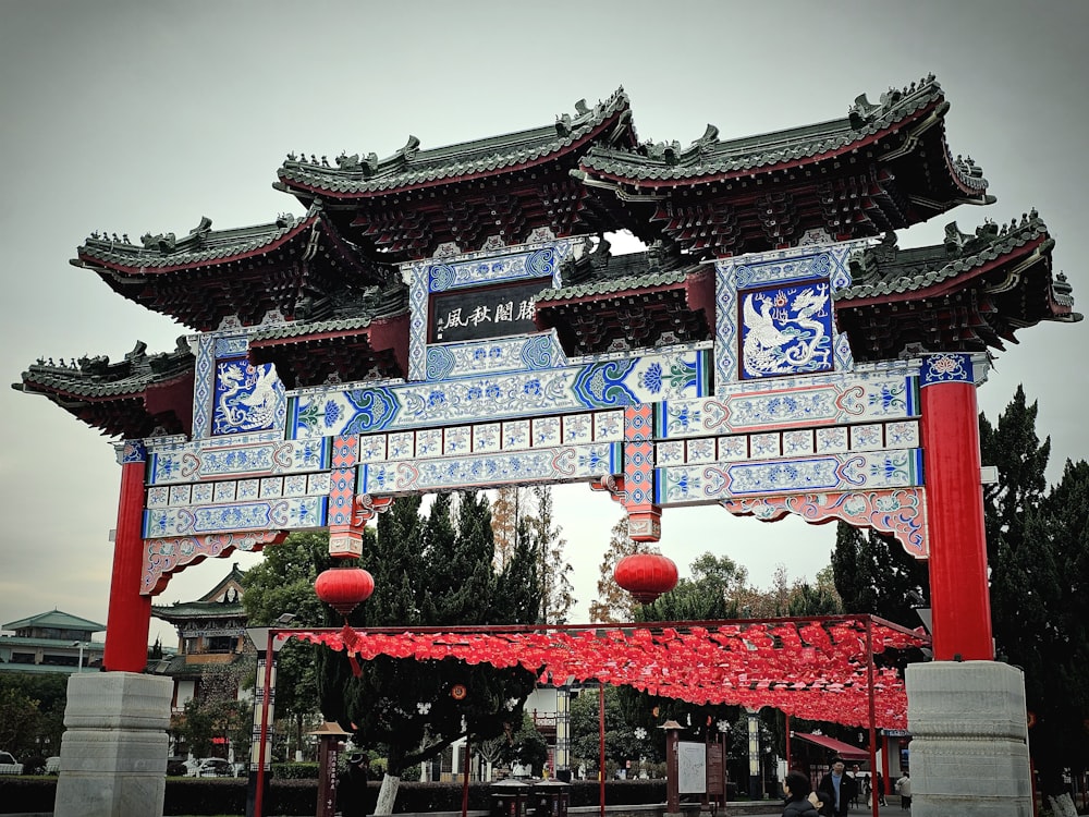 a chinese gate with red lanterns hanging from it