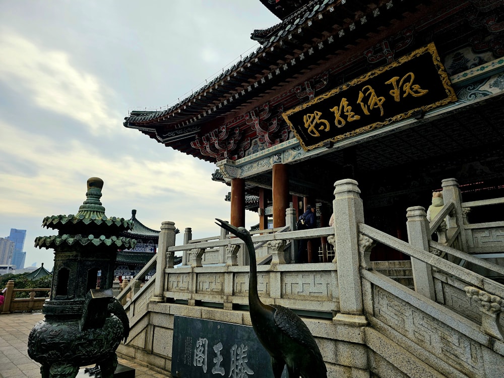 a statue of a bird in front of a building