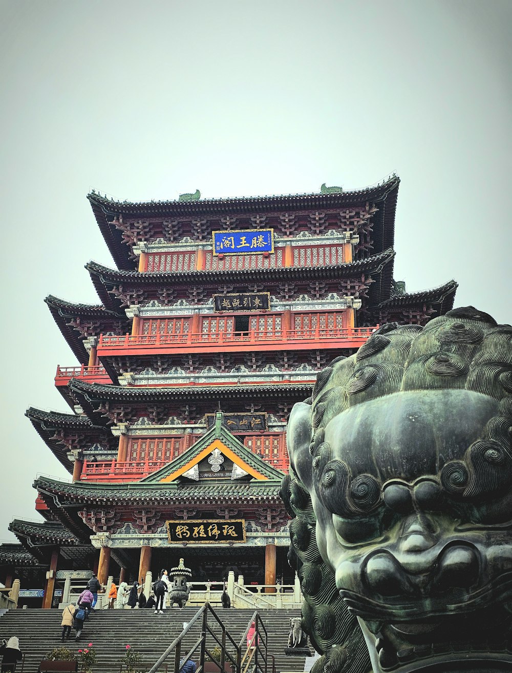 a tall building with a dragon statue in front of it