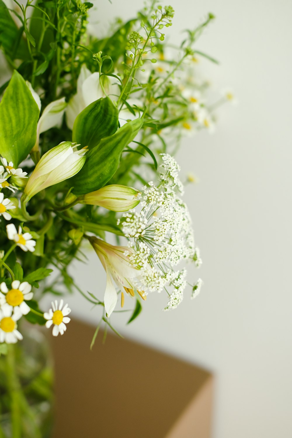 a vase filled with white and yellow flowers