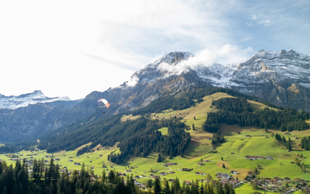 a view of a mountain range with a hot air balloon in the sky